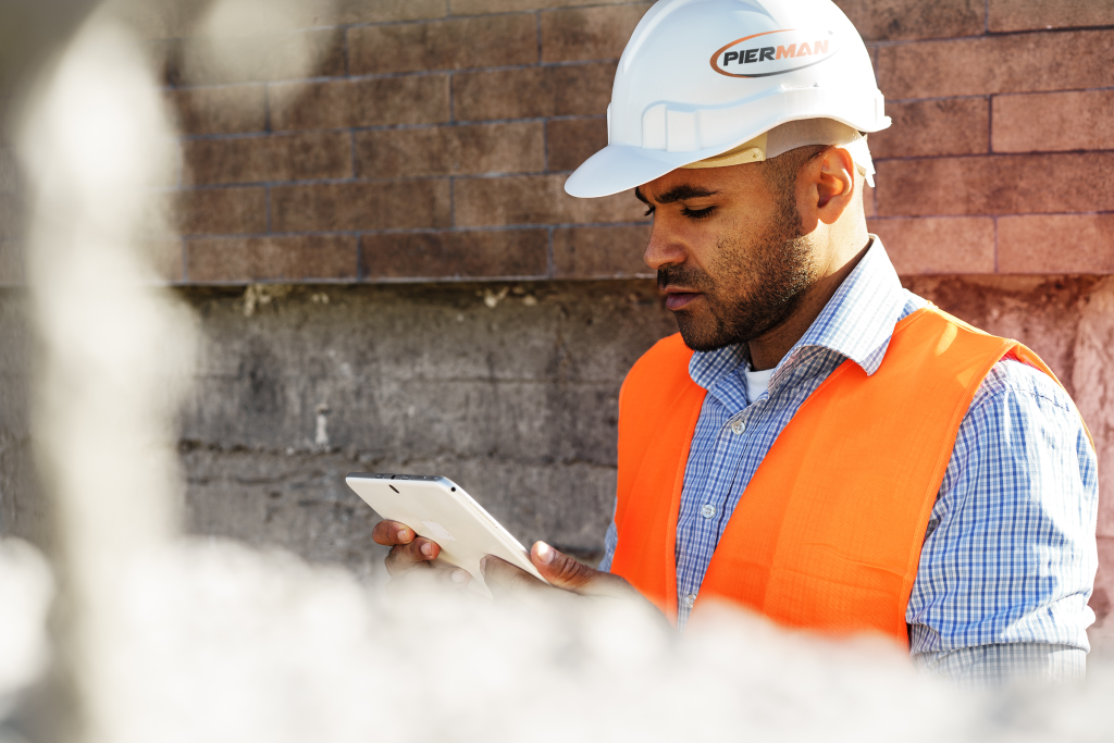 pierman foundation repair guy with white hard hat on