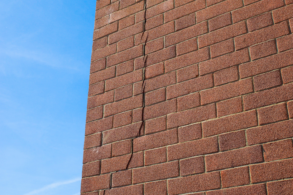 A vertical crack in a brick wall