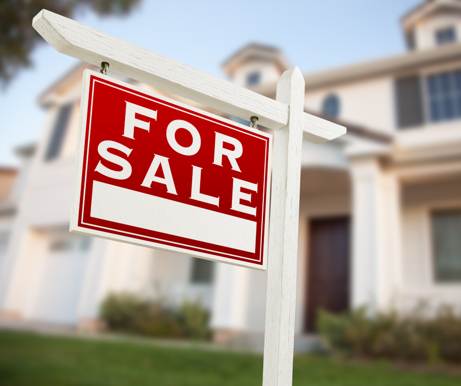 A home with a for sale sign. Foundation problems can reduce home prices